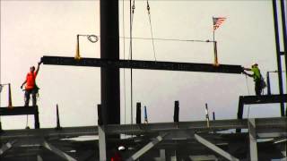 Auburn installs top beam signed by seniors on video scoreboard