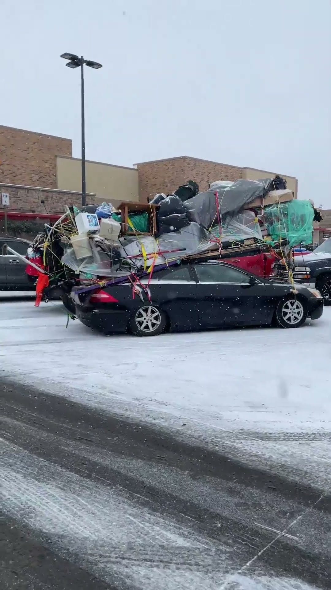 Belongings Strapped Precariously To Sedan Roof || ViralHog