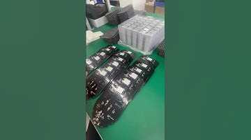 The workers are putting the batteries on the bottom plate of the light-emitting mask #factory #flash