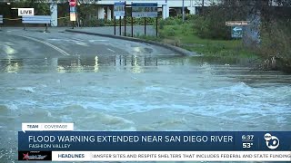 Flood waters continue to rush from San Diego River