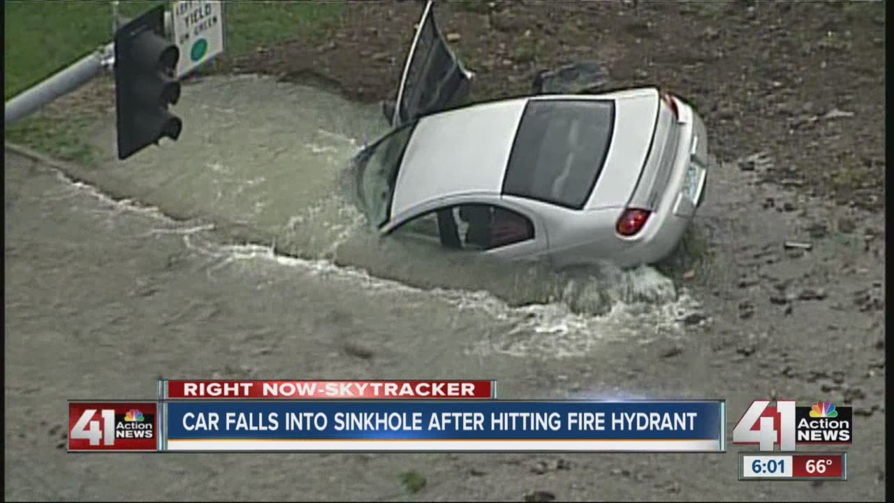 Car falls into sinkhole after hitting fire hydrant