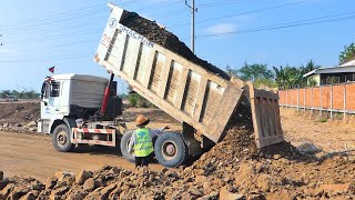 Best Dump Truck Working Drive Back Unloading Pouring soil into a road under construction Bulldozer