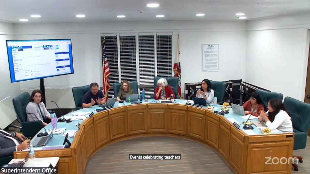 Video preview image of a video of a board room with six adults and two student board members sitting behind a semi-circle dais.; click to visit the ParentSquare post with the video