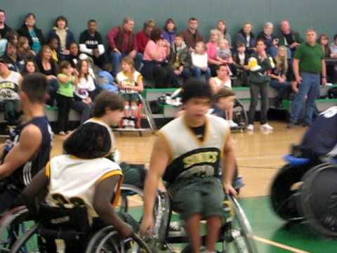 Wheelchair basketball player Nick Weiss drives the...