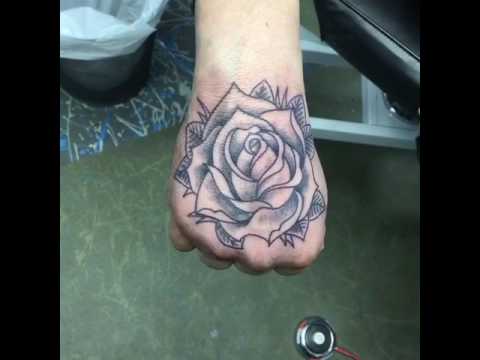 rose tattoo in hand