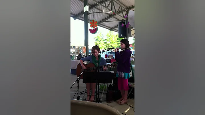 Macy singing at farmer's market