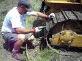 MikeMc cleaning the stuck on hard clay soil off his tracks .....