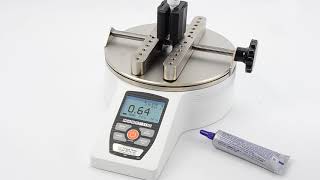 Checkline CAP-TT01 torque tester with flat jaws testing a small tube