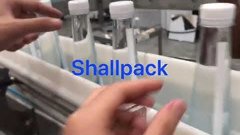 Pressure sensitive labeling on conical bottles with rotary labeling machine Shallpack