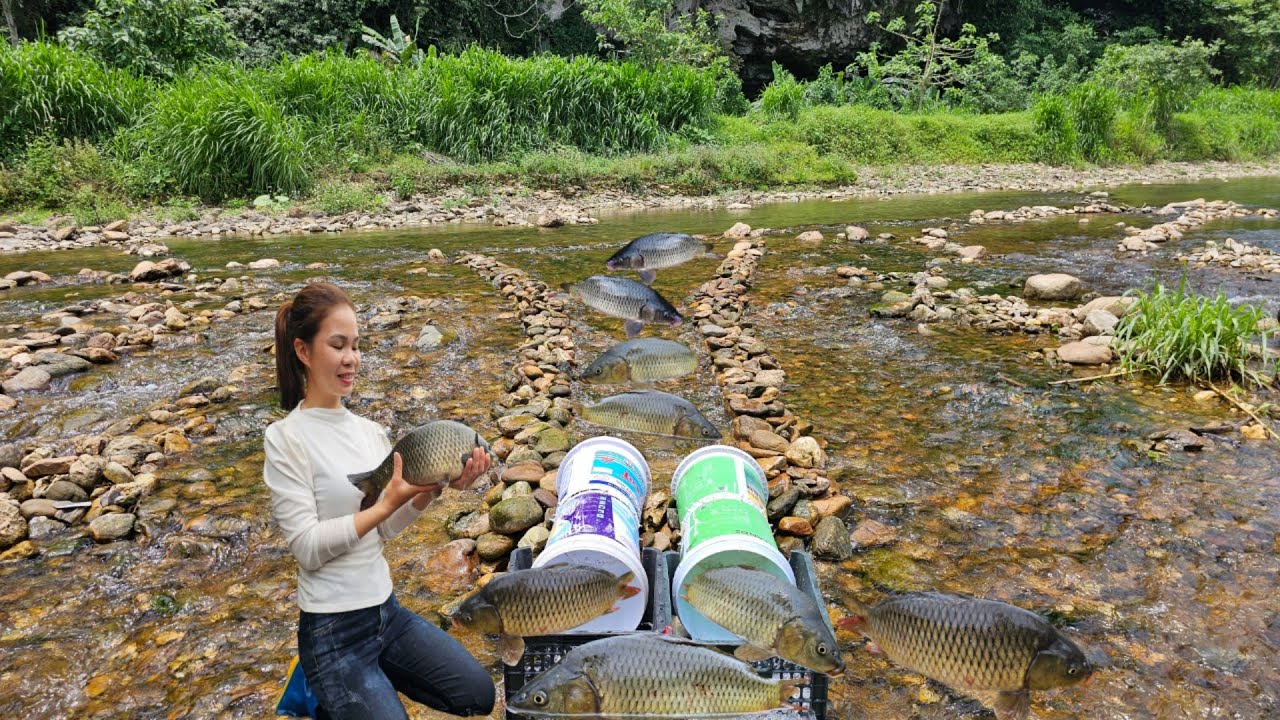 Young girl used discarded paint cans to create a very unique fish trap. And caught a catch.