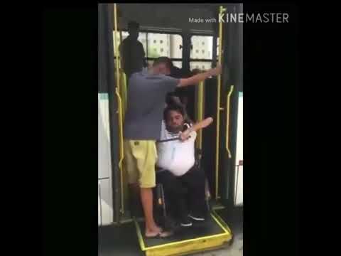 disabled man falls of his wheelchair as he is getting off the bus