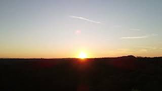 Hyper-lapse of sunrise over forest on a clear day
