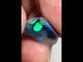 Am94 australian rough  rub semi black opal 33cts extremely bright blue  green fires