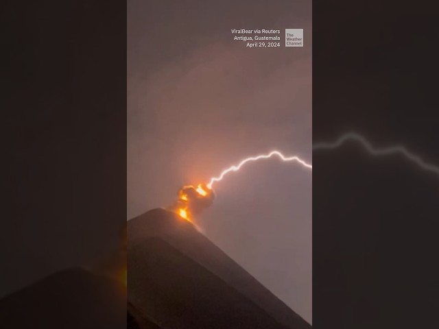 Lightning appears to strike erupting volcano