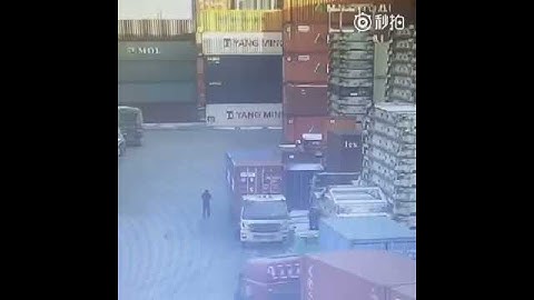 Containers fall on loading dock, crushing a car, China