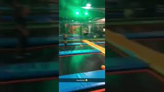 Guy throws ball at kid in trampoline park