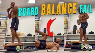 Guy Falls While Holding a Plate and Balancing on a Board