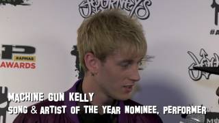 Machine Gun Kelly reveals upcoming announcements for 2017 on the APMAs red carpet