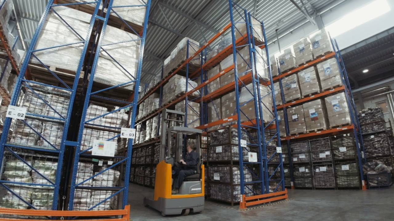 Forklift truck driver unloading pallet in storage warehouse - YouTube