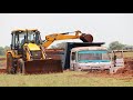 JCB Backhoe Going Mine and Loading Mud in Dump Truck