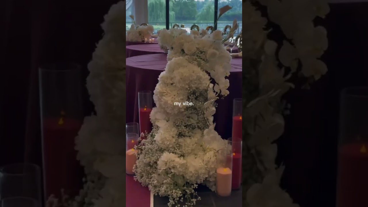 60th birthday decor inspo featuring sand candles white and ivory floral arrangements