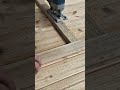 cutting wood using a jigsaw puzzle tool precisely on the wooden floorboard area of the terrace house