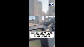 Bizarre video shows man clinging to hood of moving car in Hollywood