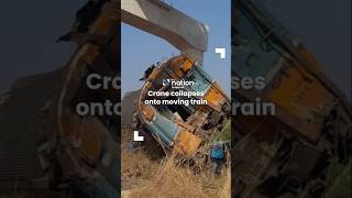 Crane collapses onto moving train