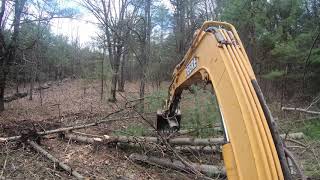 Clearing land for a cabin and cutting in a driveway