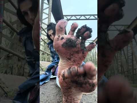 Barefoot in muddy bridge drain