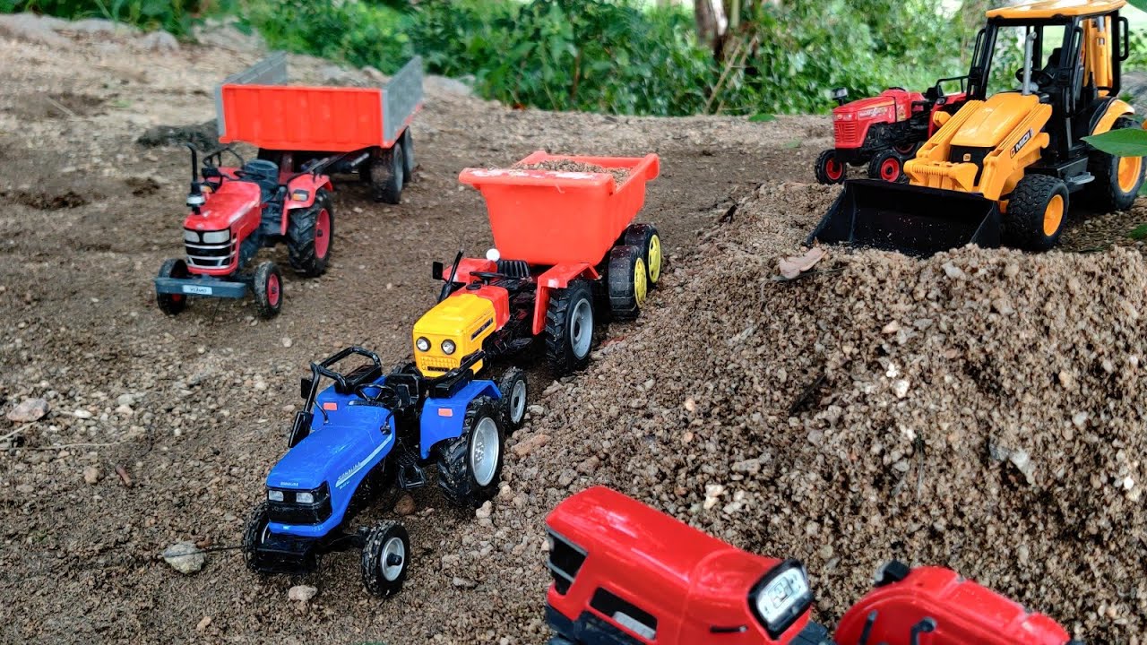 Sonalika and HMT 5911 tractors trolley fully loaded by JCB machine