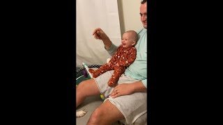 Guy and Baby Playing Fetch With a Dog Making Baby Laugh Hard About It