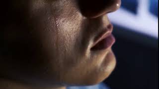 a tear flows down the cheek of a young guy slow motion