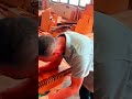 sanding multiple slots on long piece of wooden board using an orbital sander to smooth out the edges