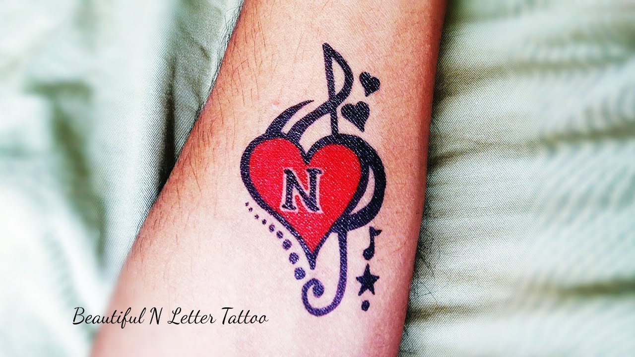 N Letter Tattoo with heart and music simble - YouTube