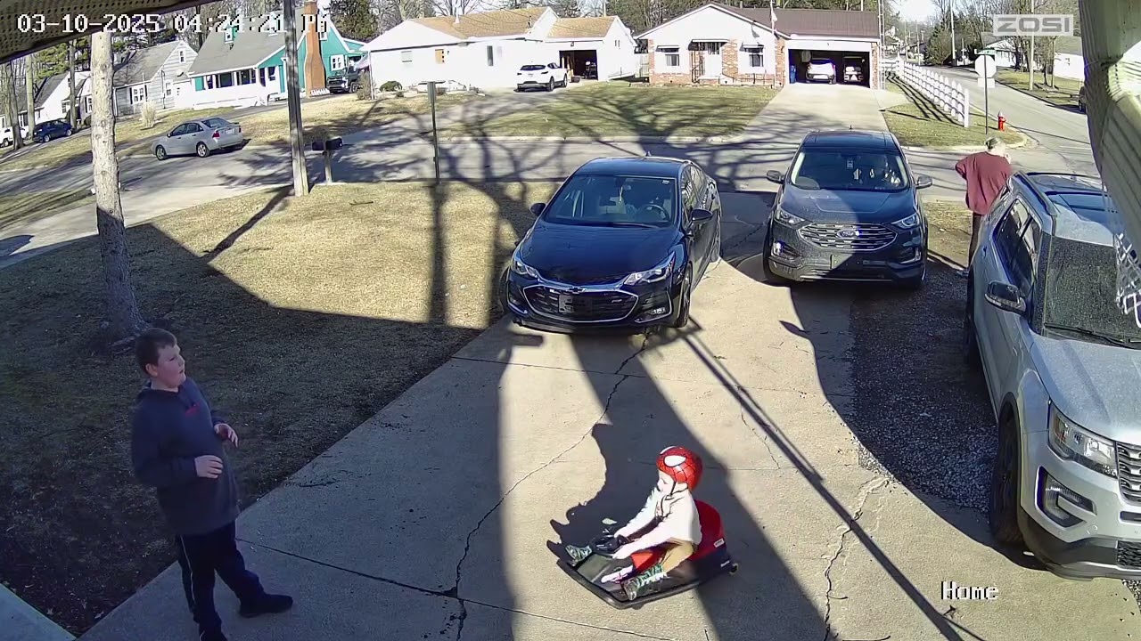 Boy wearing Spider-Man helmet rides go kart and gets hit on head by ball (Security camera)