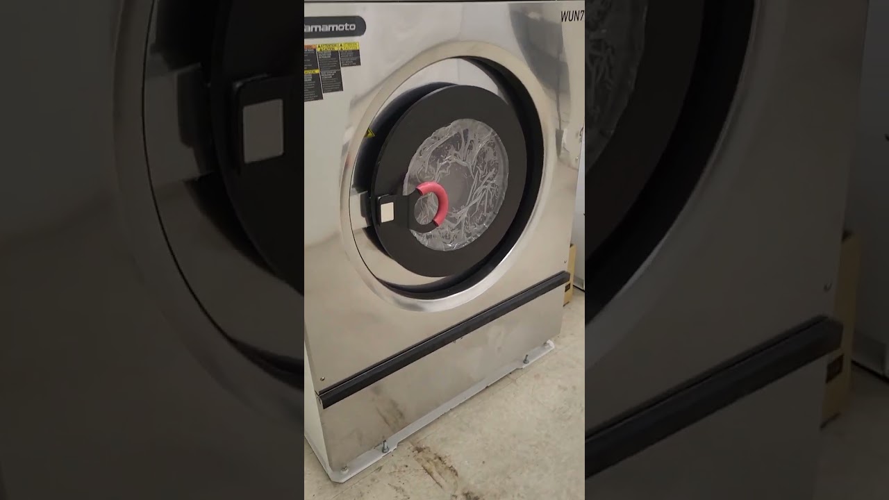 Aquawing Ozone System, Yamamoto Washer Extractors, and Huebsch Dryers in a small OPL laundry room.