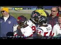 Antonio Smith and Brian Cushing fight each other in the middle of a game
