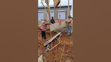 The process of building a sturdy concrete fence with an excavator