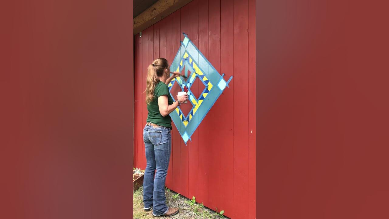 Painting a barn quilt on barn door americana folk art what is a barn
