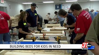 Volunteers show up to build beds for kids in need