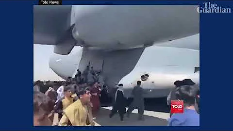 Afghans climb on to plane during takeoff in attempt to flee Taliban