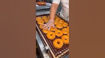 FRESH CHOCOLATE DONUTS with sprinkles.
