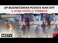 Uttar pradesh news  on cctv up businessman pushes man off 5star hotels terrace after fight