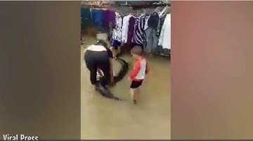 THREE-YEAR-OLD CHILD RIDES A 20FT LONG PYTHON