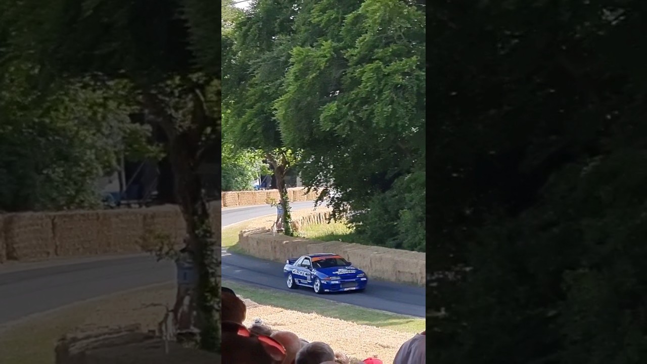 JAKE HILL BTCC driver flying up GOODWOOD hill in the NISSAN SKYLINE R32 