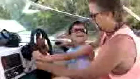 Jared driving a boat with Roger