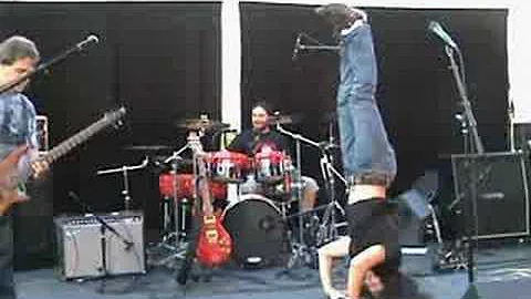 Yoga headstand on stage at Pangea Music Festival