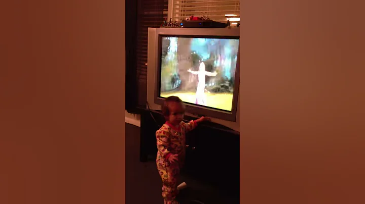 Nati watching and singing to tangled
