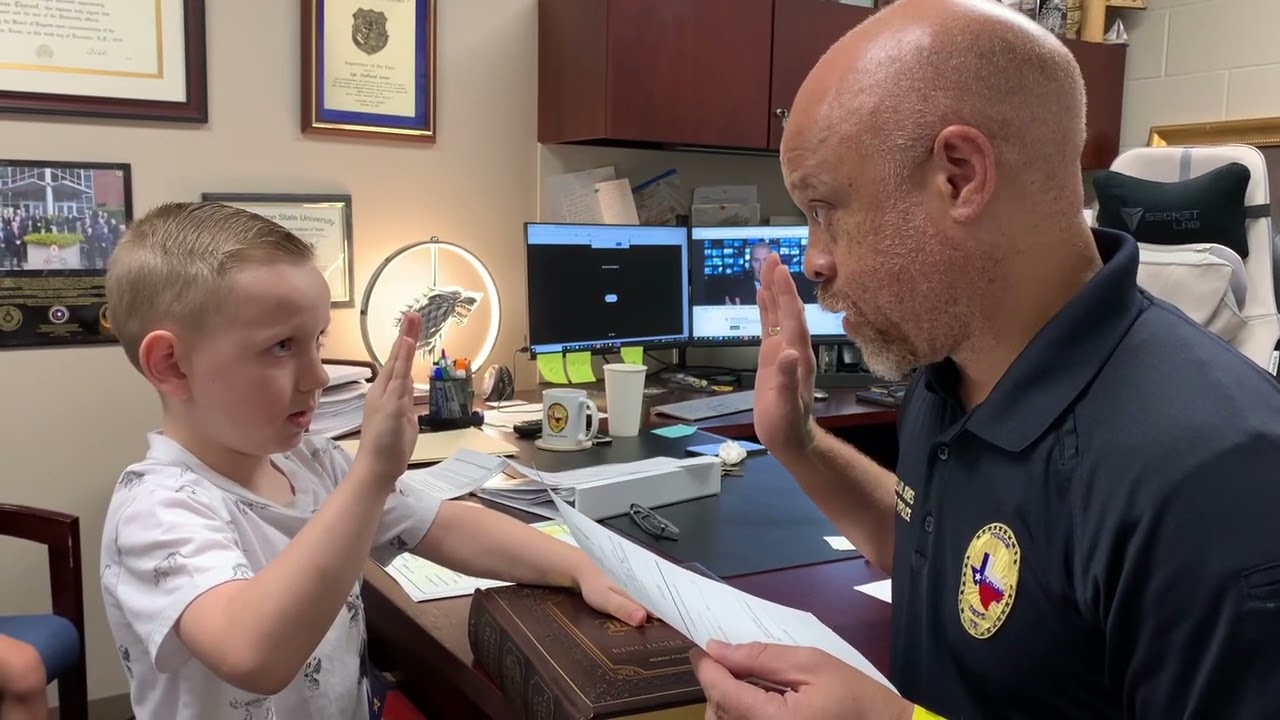 Chief Holland Jones swearing in an Honorary Police Officer: Michael May 22, 2023